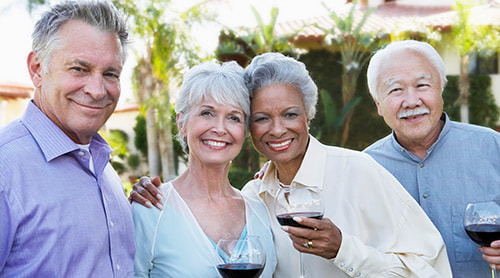 Happy elders while holding a glass of wine photo